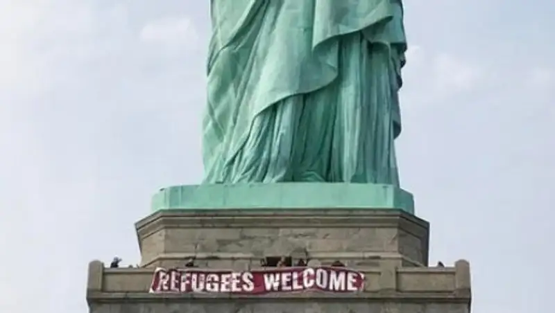 На статую Свободы повесили плакат с приветствием беженцам