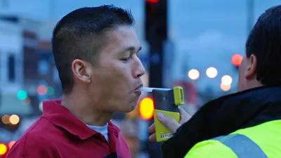 мужчина дышит в трубку для выявления алкоголя, фото - Новости Zakon.kz от 08.09.2025 11:48
